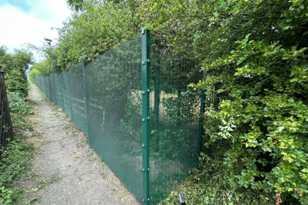 Green 358 high security mesh fencing installed along a school boundary path at Denholme Primary School, Bradford