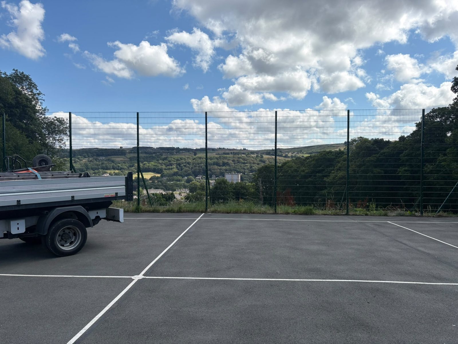 Mesh fence post and diagonal strut at a school boundary above the Aire valley
